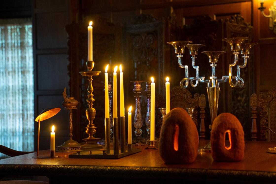 Photograph of candlesticks and sculptures on a table in Cranbrook House