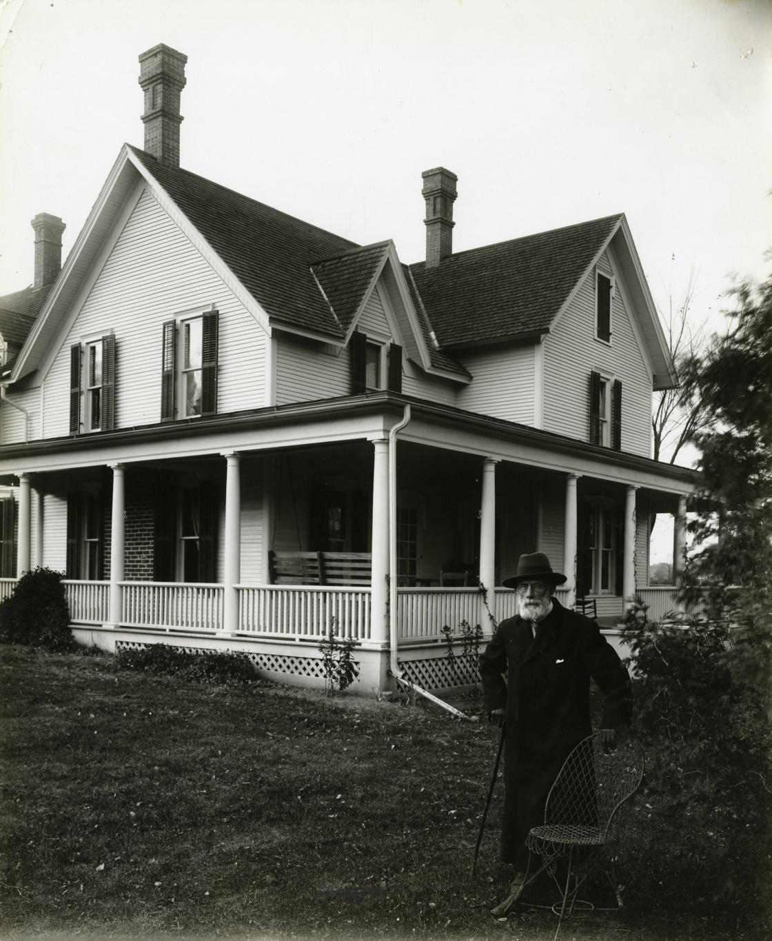 Henry Wood Booth, circa 1912. Photograph Collection of Cranbrook Archives (CC278-1). Henry Booth is standing in the yard of the Cottage at Cranbrook. The view is of the east side of the house, which faced Cranbrook Road.