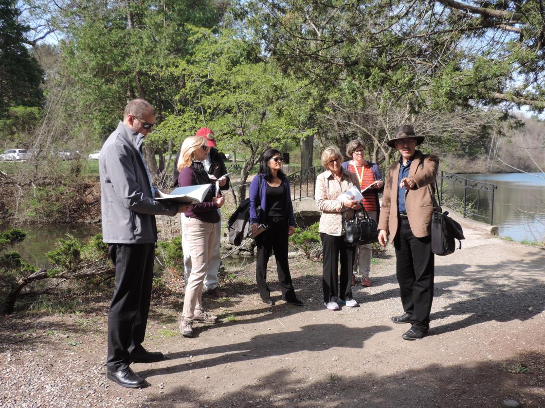 Dr. Kendall Brown of California State University leads a tour of the Cranbrook Japanese Garden for the Center staff and Subcommittee Members 