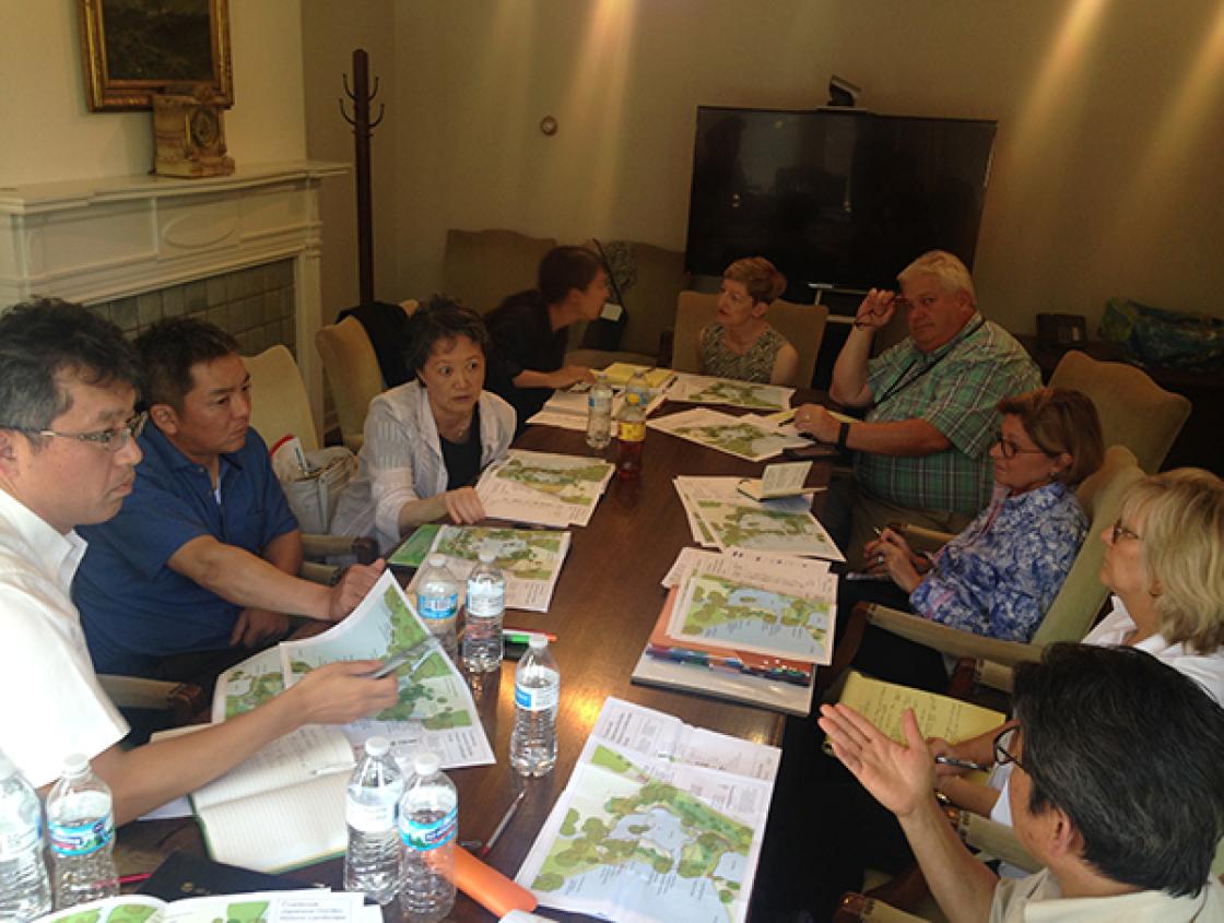 Photograph of Lily Pond Cascade Rehabilitation Planning Meeting in Cranbrook House, July 13, 2018. Attendees include (clockwise from left): Ryuichi Wakisaka (MLIT); Yasumasa Imada (Japan Federation of Lanscape Contractors); Yuki Sakai, Mayuko Chashiro, an