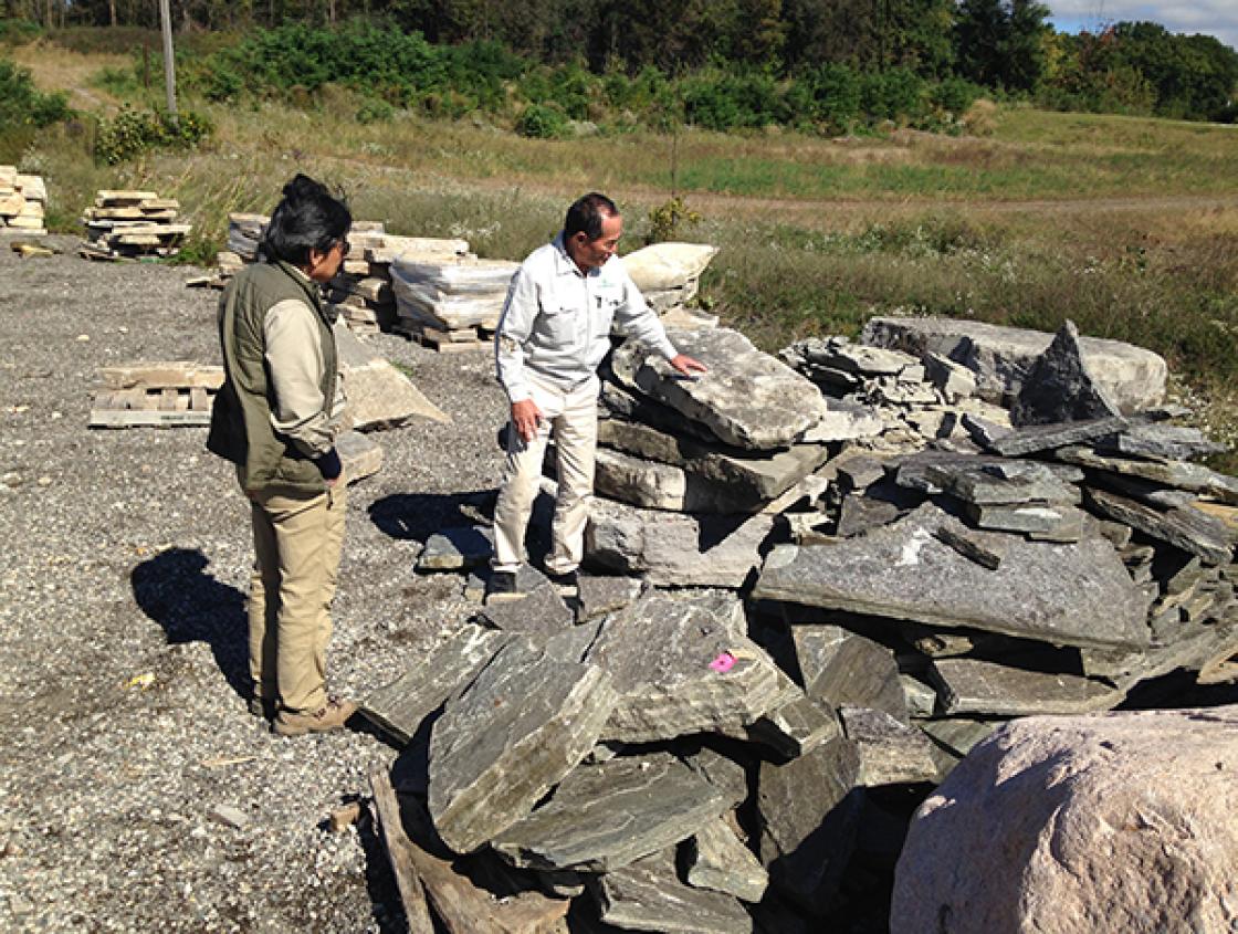 Sadafumi Uchiyama (left) and Hiromu Terashita Select Stone Slabs for Lily Pond Cascade Bridges at Orion Stone Wholesale in Orion, Michigan, October 4, 2018. Photography by Gregory Wittkopp.