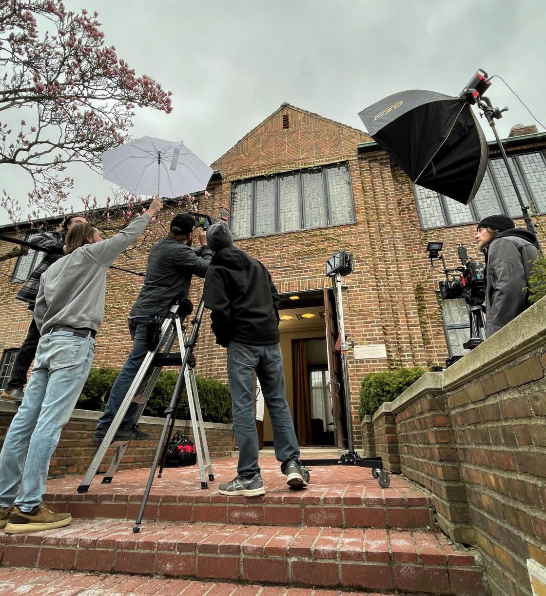 Photograph of the production crew preparing to film outside Saarinen House