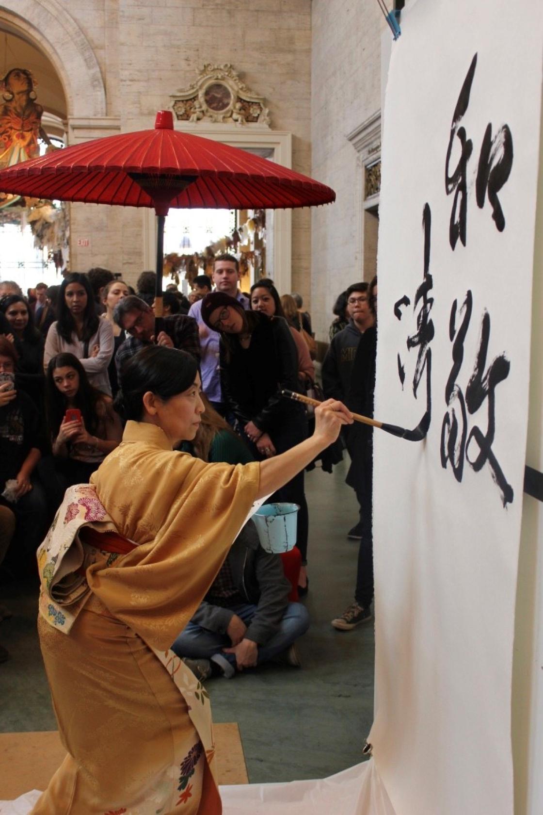 Kyoko Fujii demonstrating traditional Japanese calligraphy